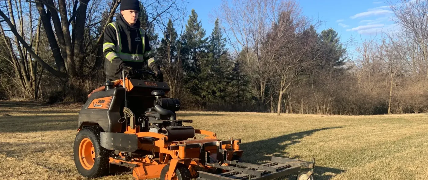 Professional providing lawn care basics with commercial mower in Middleton, WI