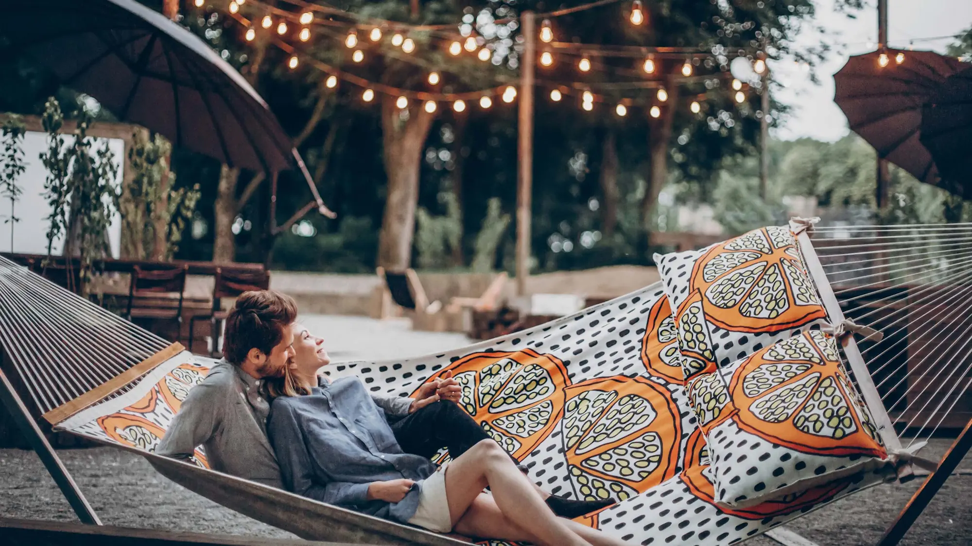 Couple sitting on a hammock during a nice sunset