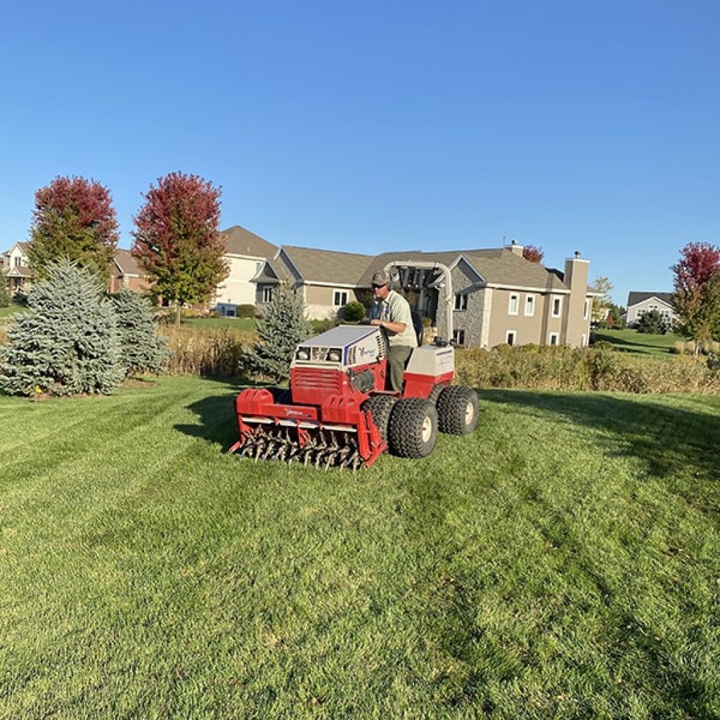 Staff mowing the lawn for landscaping and lawn maintenance in Middleton, WI.