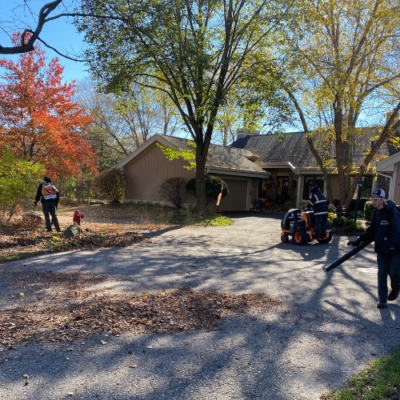 Carrington Lawn & Landscape staff infront of a house, on a lawn in a process of landscape maintenance in Middleton, WI