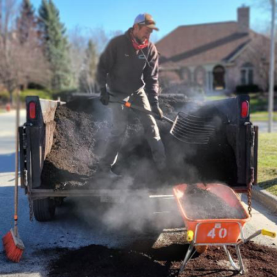 Carrington Lawn & Landscape staff on top of a truck doing a landscape maintenance in Middleton, WI