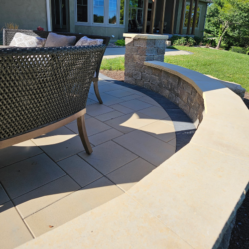 Close view of curved seating wall and patio pavers at Carrington Lawn & Landscape’s multi level patio in Wisconsin