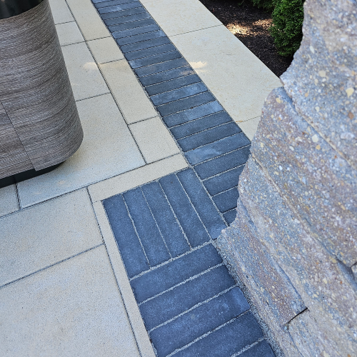 Closeup of contrasting border pattern on multi level paver patio by Carrington Lawn & Landscape in Wisconsin