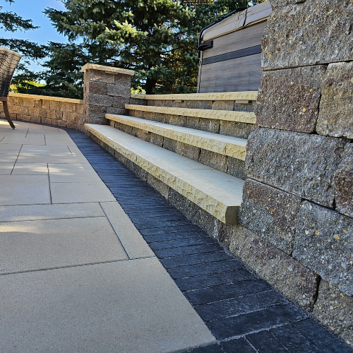 Large stone steps connect different levels of a paver patio built by Carrington Lawn & Landscape in Wisconsin