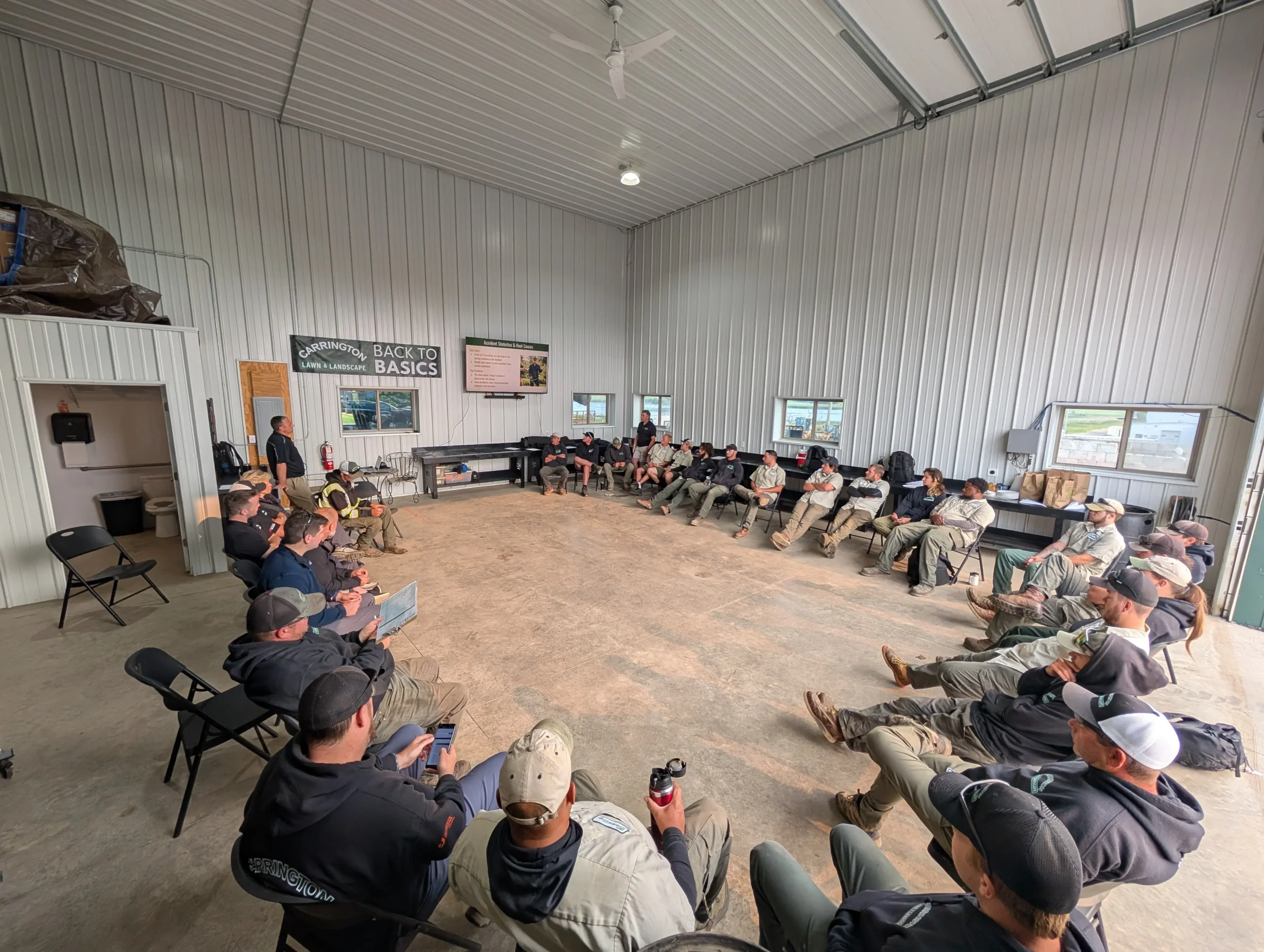 Carrington Lawn & Landscape staff gathered for a team meeting inside the Madison facility, focused on training and planning