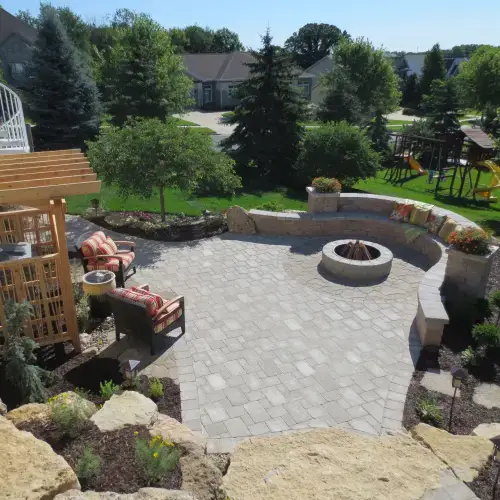 Modern backyard with stylish fire pit and seating area featuring the latest landscape design trends in Middleton, WI