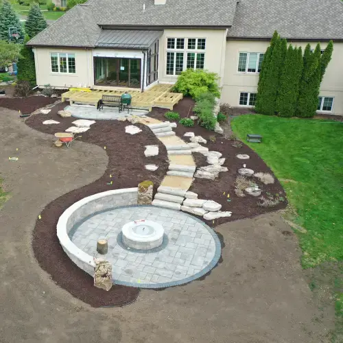 A beautifully landscaped backyard showing professionally installed pathways, rock features, and the basics of lawn care at a Middleton, WI home.