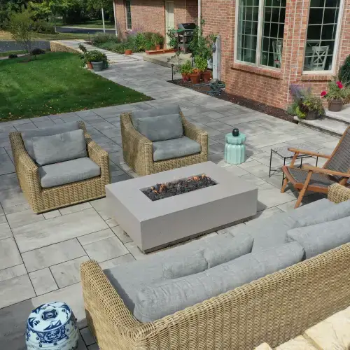Contemporary outdoor patio with modern fire pit and stylish seating, showcasing the latest fire pit landscape design trends in Middleton, WI