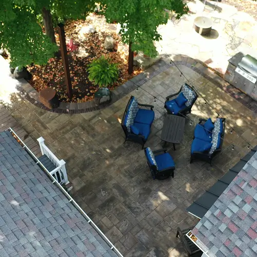 Shaded patio seating integrated into climate-adapted landscaping by Carrington Lawn & Landscape in WI