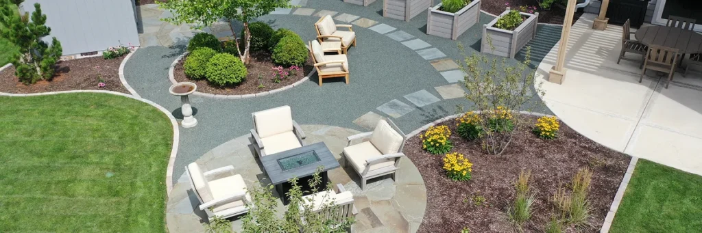 Finished backyard patio with seating area and garden after landscape project preparation by Carrington Lawn & Landscape in WI