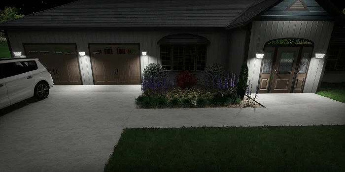 Front entrance landscape lighting illuminating shrubs and driveway showcasing landscape design cost ideas by Carrington Lawn & Landscape in WI