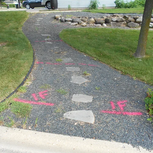 Marked layout for walkway installation showing pre-construction phase of landscape project preparation by Carrington Lawn & Landscape in WI