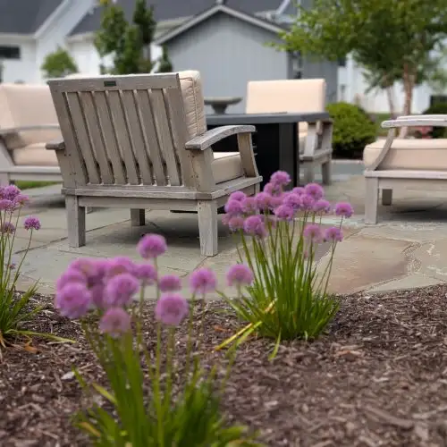Close up of seating area and garden in bluestone patio landscape design by Carrington Lawn in Middleton WI