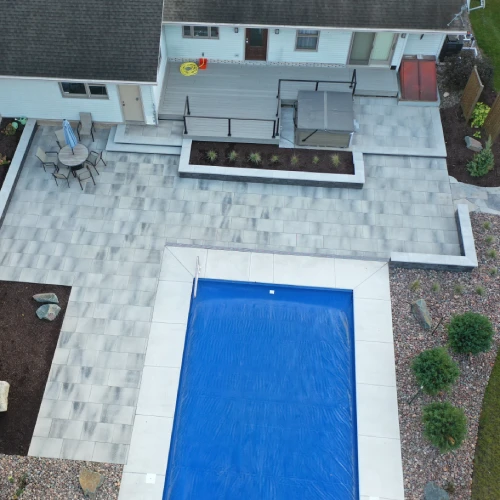 Top view of contemporary pool deck and patio with seating area by Carrington Lawn & Landscape in Monona, WI