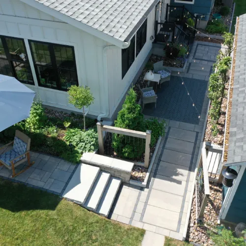 Drone view of a finished backyard patio and walkway project that reflects positive customer testimonials by Carrington Lawn & Landscape | Madison in WI