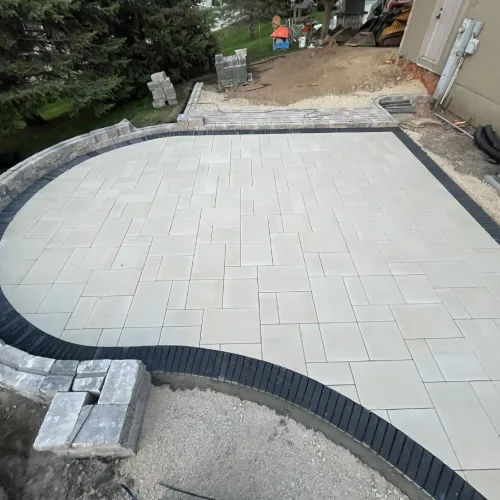 Curved paver patio under construction showing the detailed installation process that clients appreciate by Carrington Lawn & Landscape | Madison in WI