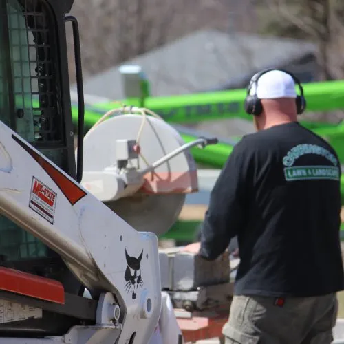 Landscape installation crew building hardscape and planting garden elements with precision and care by Carrington Lawn & Landscape in WI