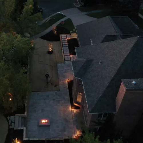 Homeowners and landscape project manager reviewing the completed outdoor space during final walkthrough by Carrington Lawn & Landscape in WI