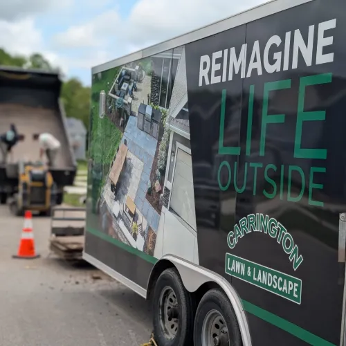Project manager and crew leader reviewing outdoor design plans during pre-construction walkthrough by Carrington Lawn & Landscape in WI