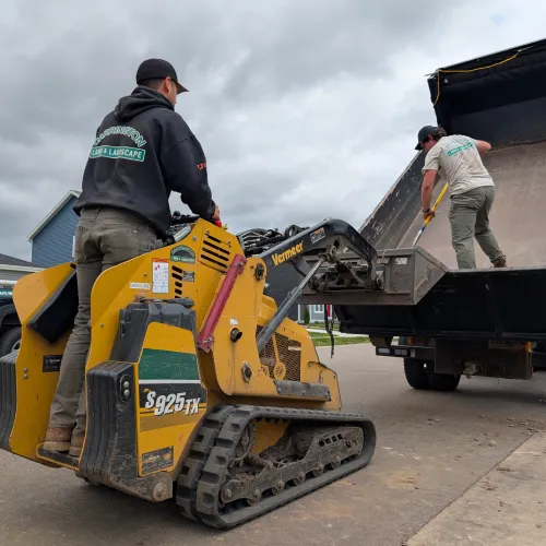 Landscape team planning project schedule and preparing materials for outdoor installation by Carrington Lawn & Landscape in WI