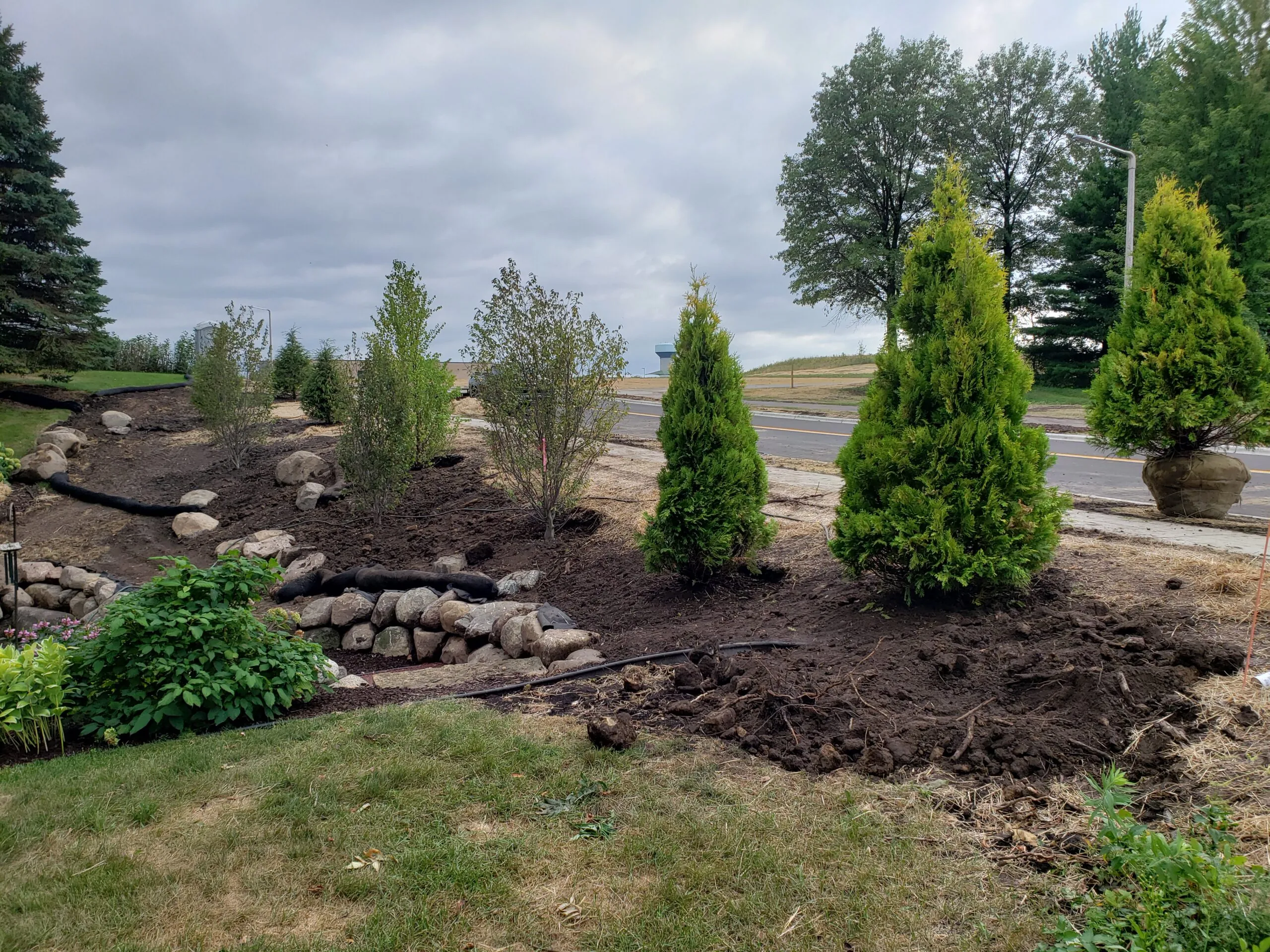 A landscape design build by Carrington Lawn & Landscape featuring a variety of plants, trees and hardscape in Middleton, WI