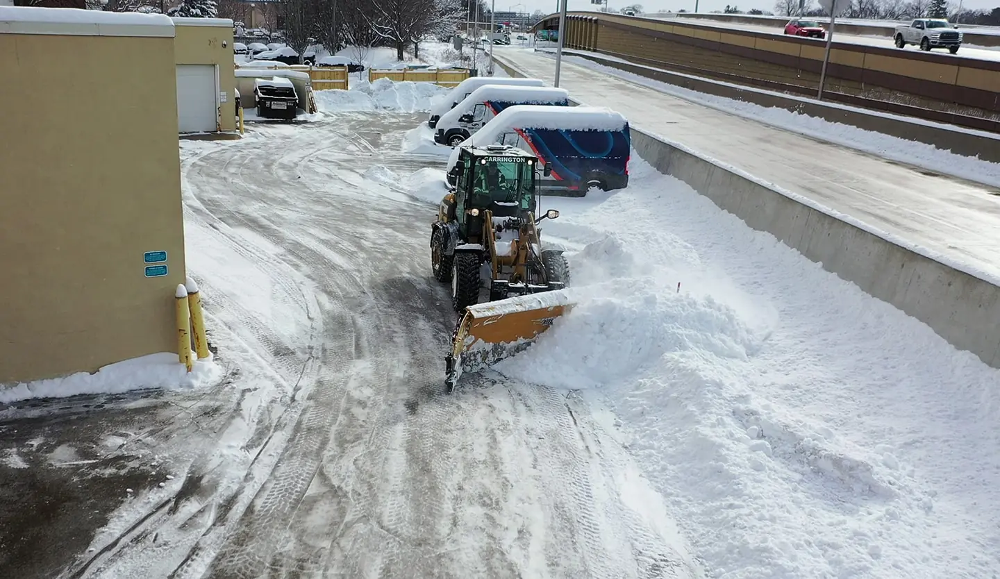Mobile equipment for clearing snow from a parking lot during a snowfall for snow and ice management in Madison, WI