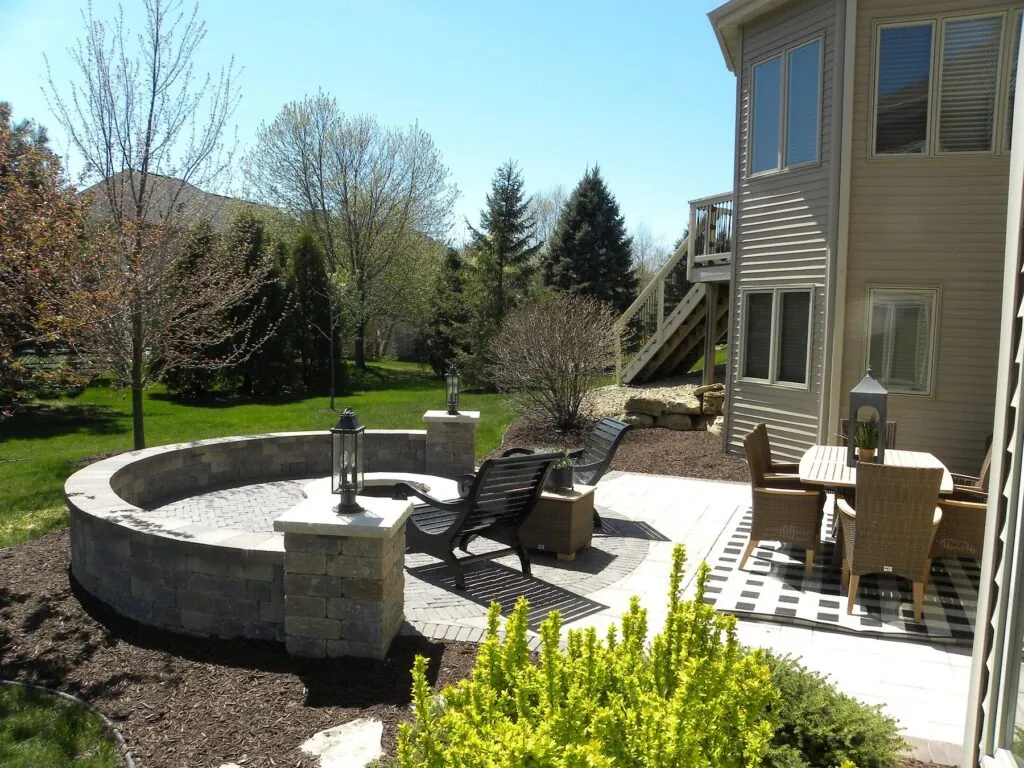 Newly hardscape design patio with white and grey stone bricks and elegant garden in in Middleton, WI