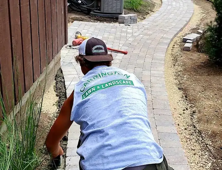 Carrington lawn and landscape team member in a process of landscape maintenance in Middleton, WI