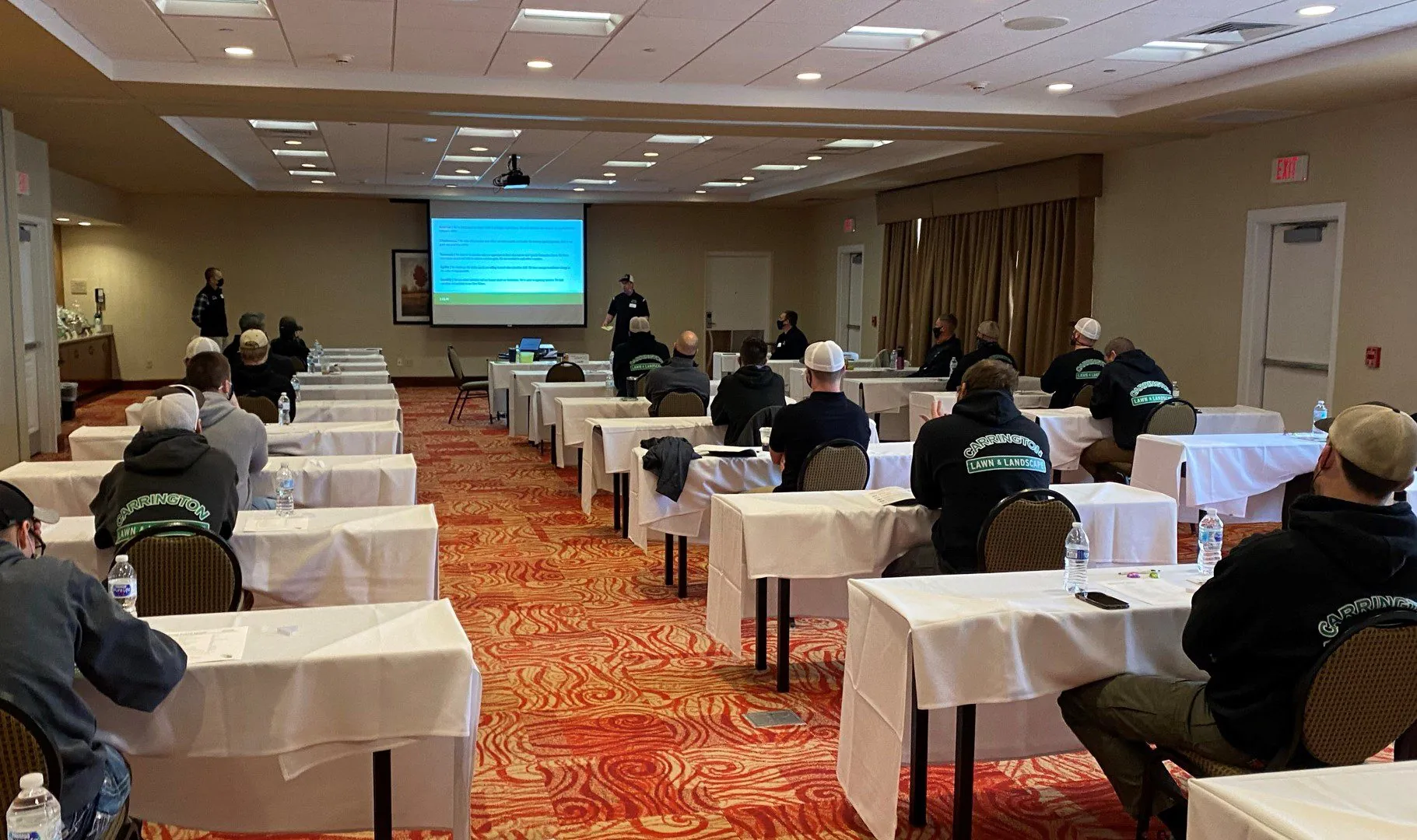 Several Carrington Lawn & Landscape team member in a conference room discussing snow and ice management plan in Madison, WI
