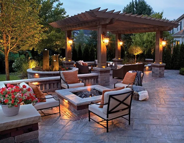 Outdoor patio with seating and fire pit with landscape lighting design in Middleton, WI