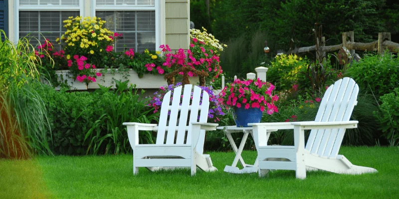 Front yard with flower beds and chairs that had a lawn maintenance in Middleton, WI