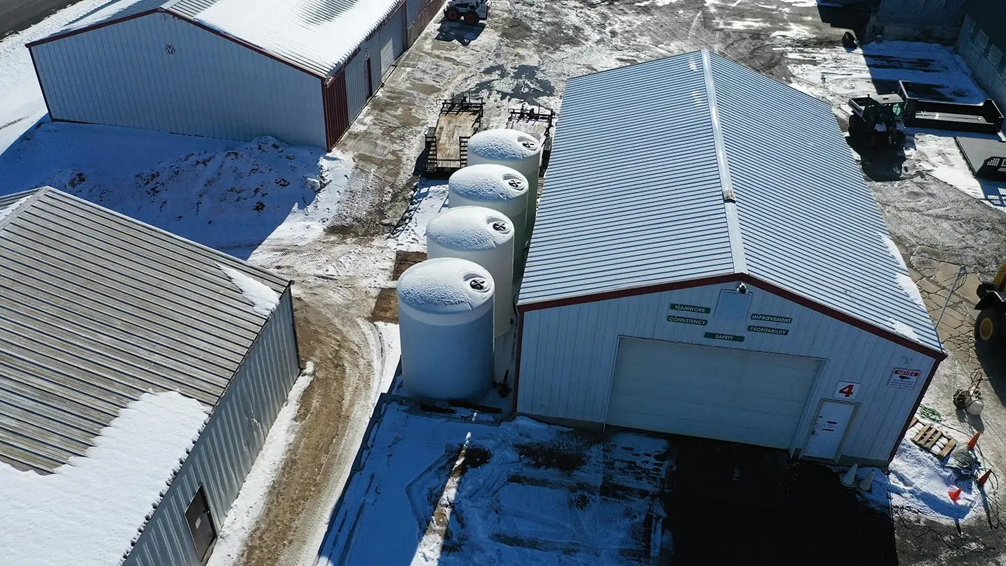 Aerial view of a snow and ice management facility with storage tanks and equipment by Carrington Lawn & Landscape in Middleton, WI.