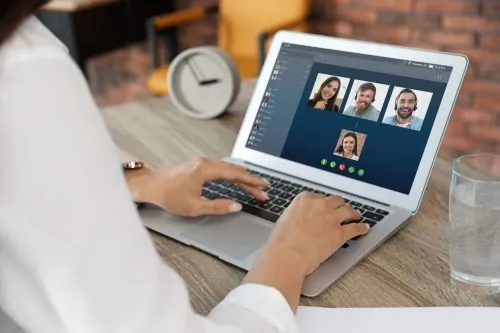 Person on a laptop having a call with multiple people for landscaping services in Middleton, WI