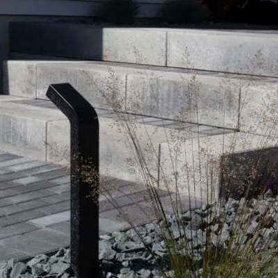 Hardscape lighting on textured gray stone steps for landscape lighting design by Carrington Lawn & Landscape in Middleton, WI
