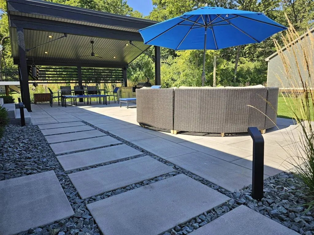 Pathway with stone border and hardscape design, showcasing hardscape design leading to a house entrance.