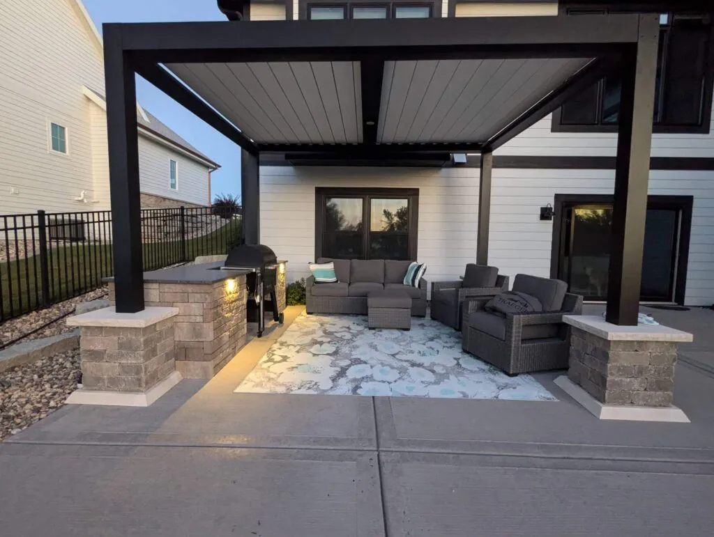 Hardscape design outdoor patio with pergola, seating, grill, and kitchen counter in Madison, WI