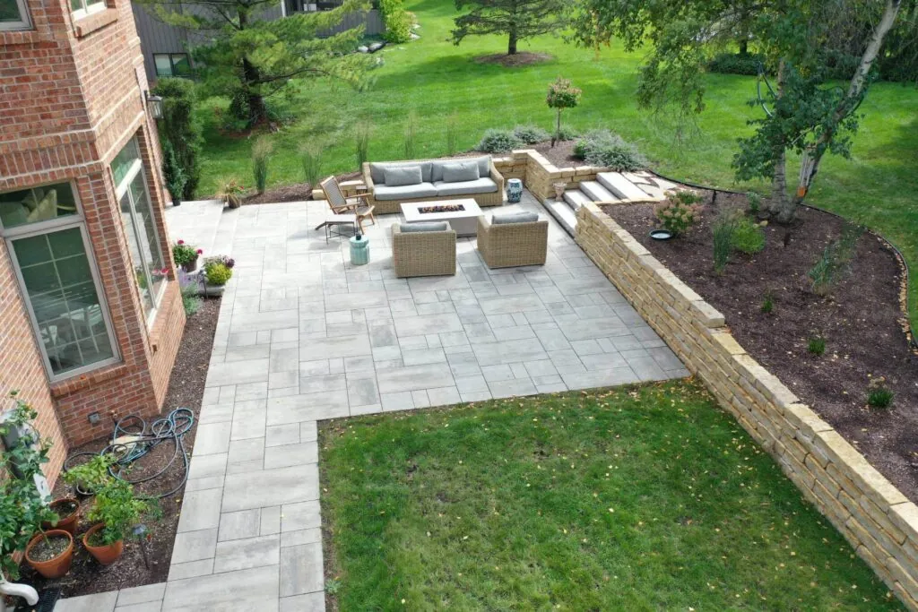 Aerial view of a patio with seating, retaining wall, and landscaping, showcasing hardscape design in Middleton, WI