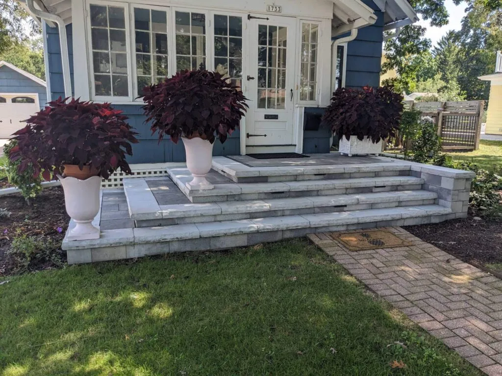 Front steps with planters, showcasing hardscape design at a house entrance in Middleton, WI
