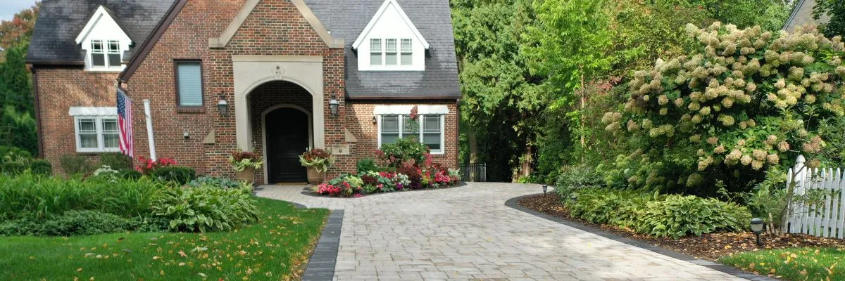 Paver Patio Installation of long driveway leading to a brick home. Landscape design and installation by Carrington Lawn & Landscape in Middleton, WI