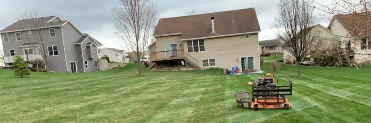 Carrington team member providing mowing service to a large backyard on a riding lawn mower in Middleton, WI.