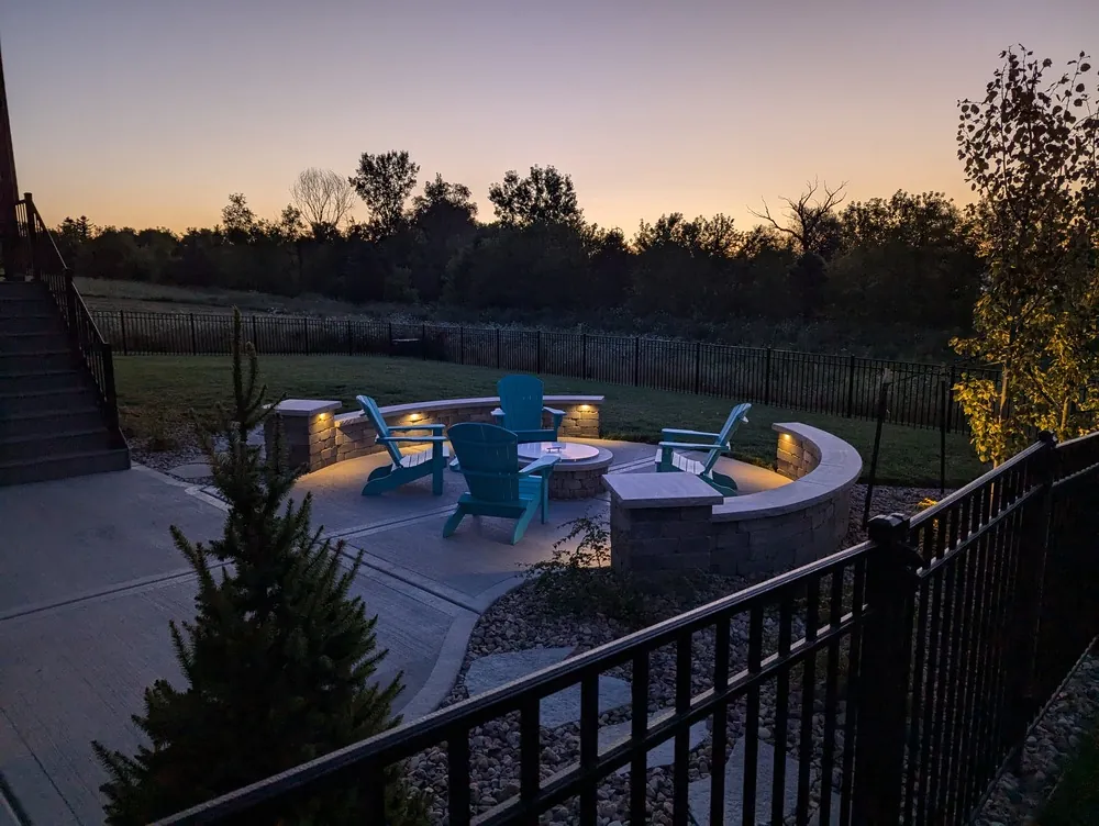 Modern backyard retreat with hardscape design by Carrington Lawn & Landscape