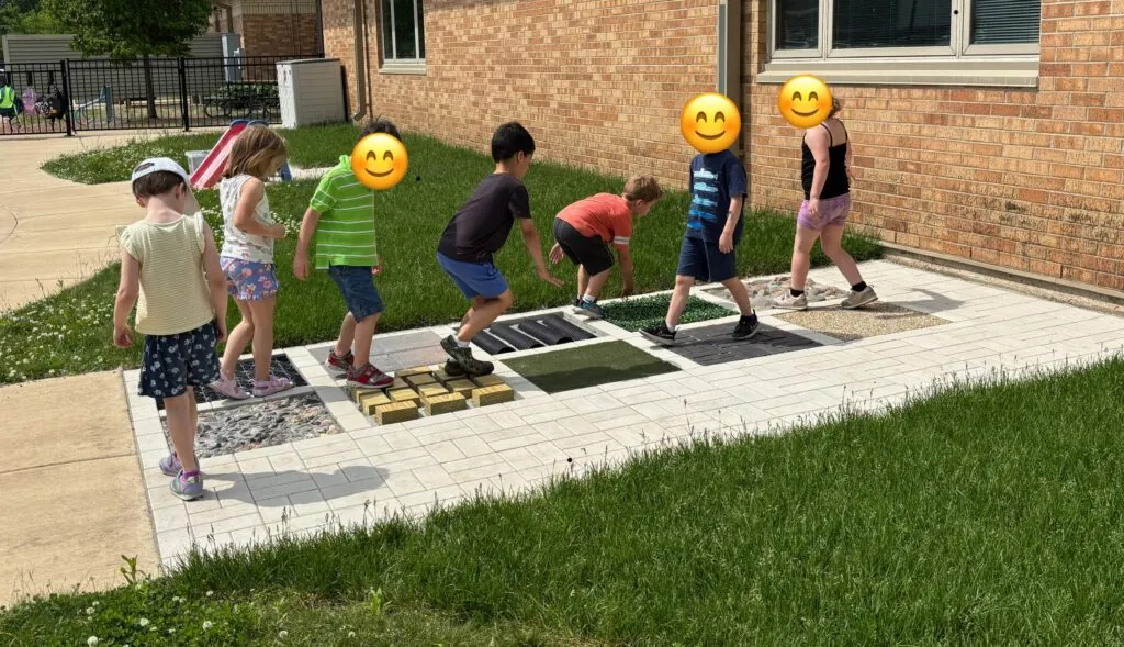 A group of children explore the newly installed sensory walkway. 