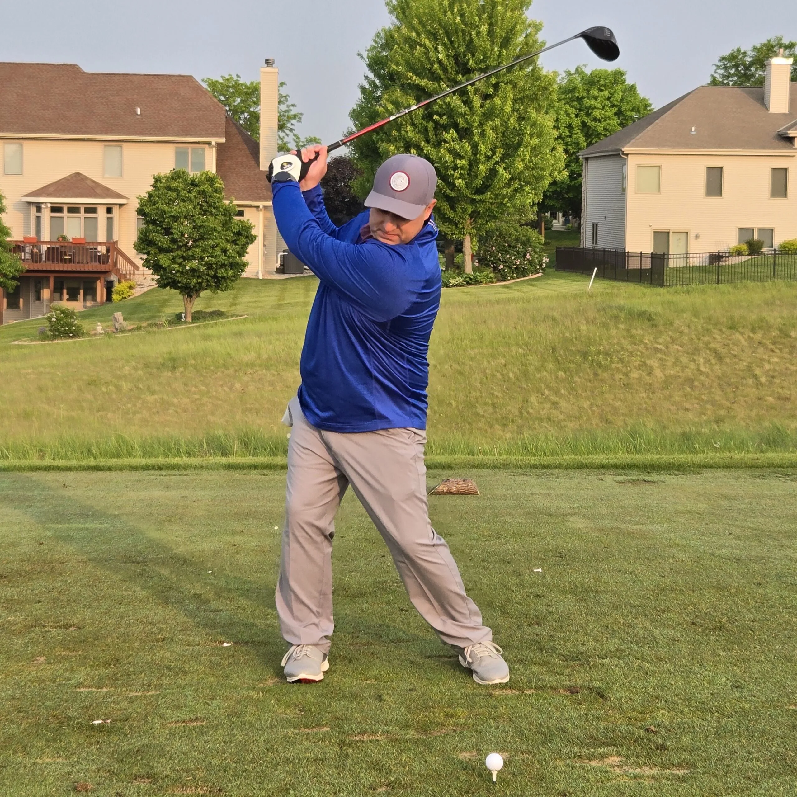 Photo of Sean Carrington, President & Founder, at the tee box on his backswing in casual attire