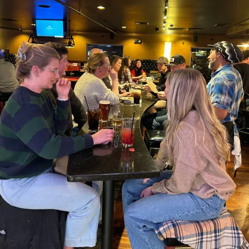 Carrington Lawn & Landscape team members enjoying drinks and conversation during the holiday party in Madison₹