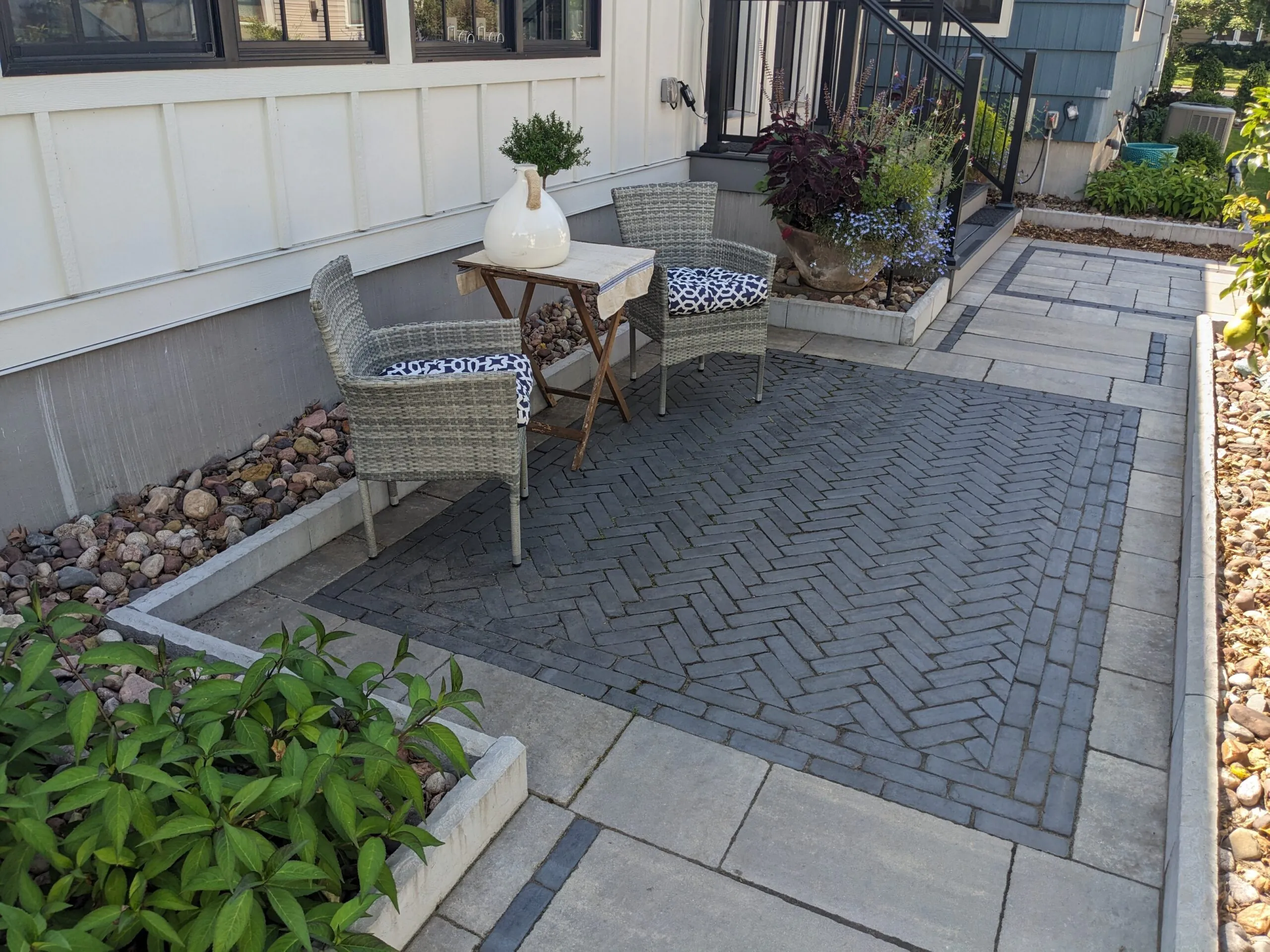 Dark herringbone inlay patio featuring the best patio material Wisconsin backyard installation in Middleton by Carrington Lawn & Landscape