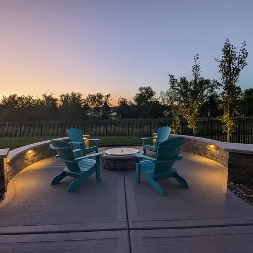 Curved custom paver patio and fire pit seating area in Madison WI by Carrington Lawn & Landscape